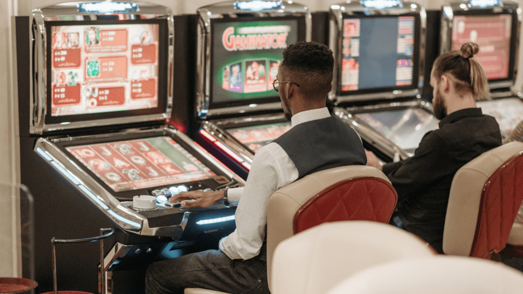 A person playing a slot machine in a casino