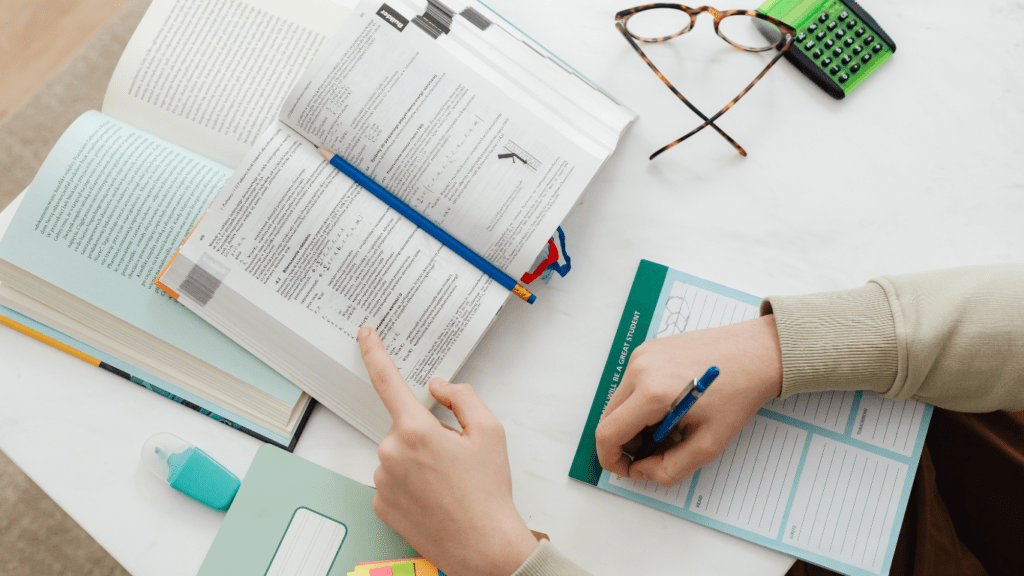 a person writing on a book