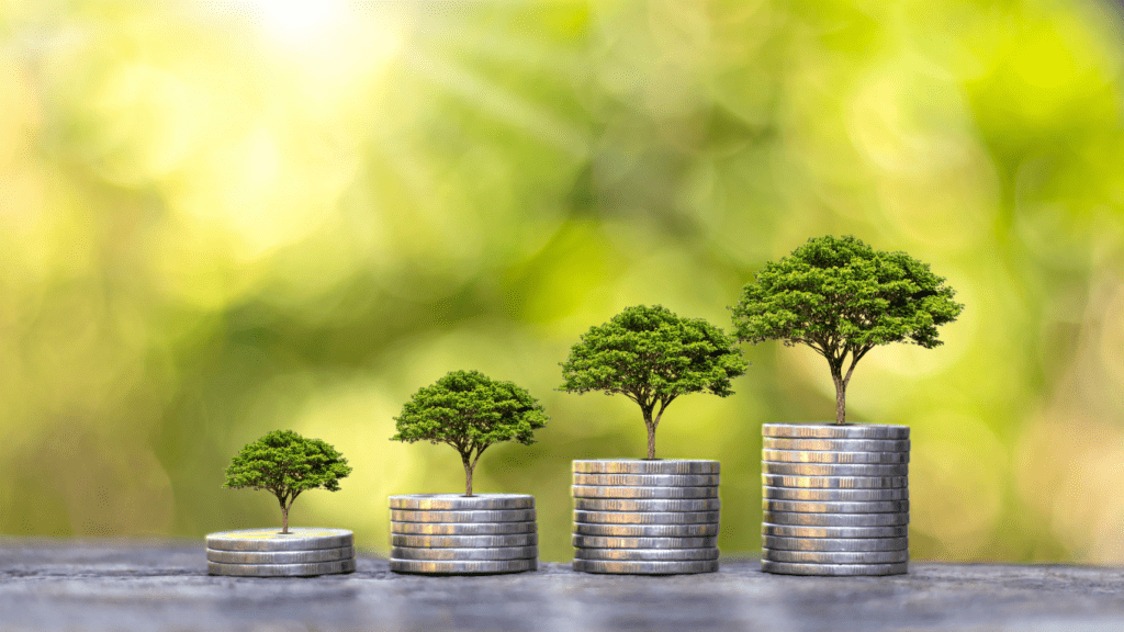 coins stacked on top of each other with trees growing out of them