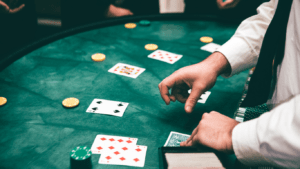 a person in a suit and tie playing cards at a casino table