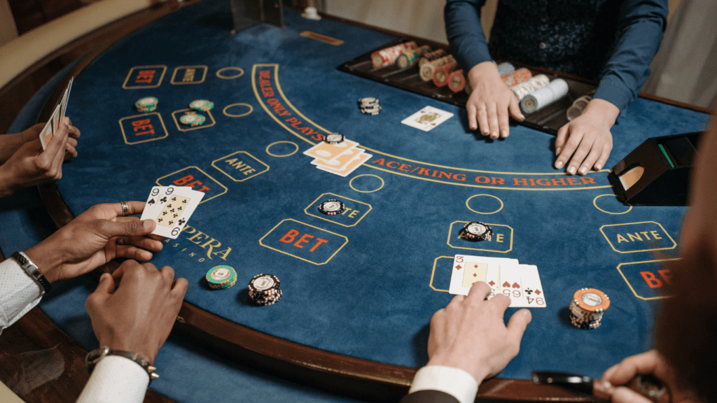 a group of people playing blackjack at a casino table