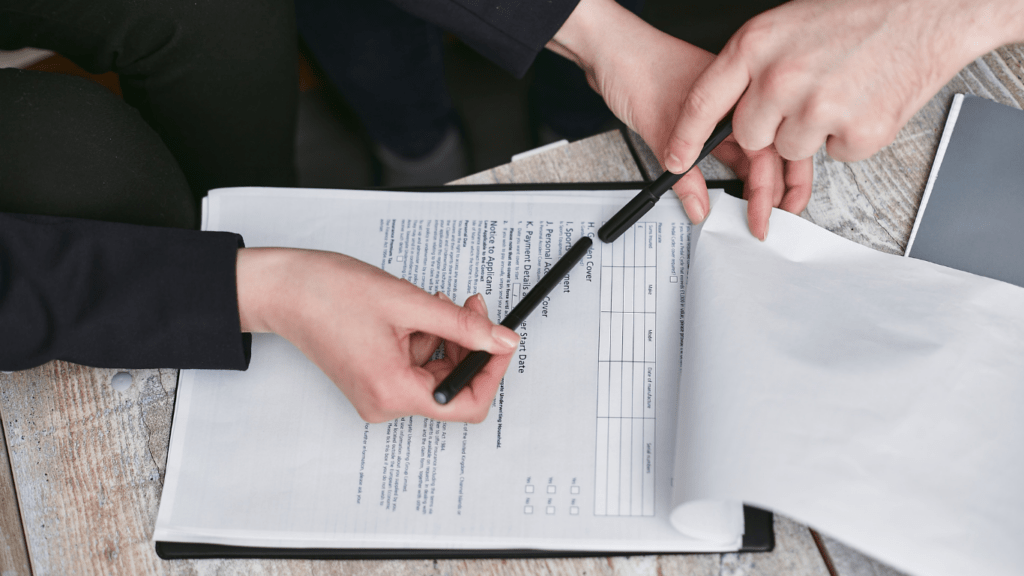 a person in a business suit is holding a clipboard