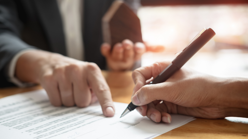 a person signing a contract 