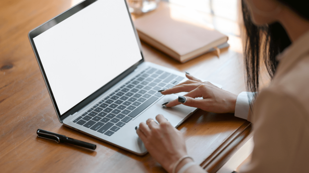 a person sitting on the chair while using a laptop