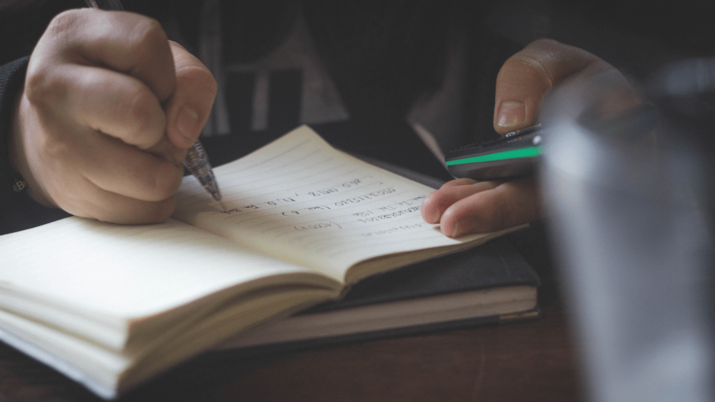 a person writing on a book