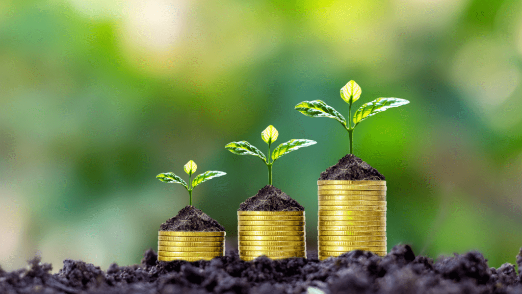 coins stacked on top of each other with trees growing out of them