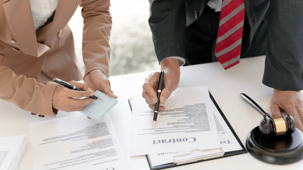 two people sitting at a desk with a gavel